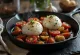 Burrata sült paradicsommal, friss salátával és balzsamecettel tálalva.