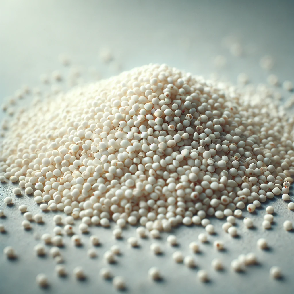A képen fehér quinoa magok láthatók, amelyek finom textúrával és enyhén áttetsző felülettel rendelkeznek.