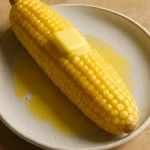 Elote vajjal, parmezánnal és korianderrel díszítve