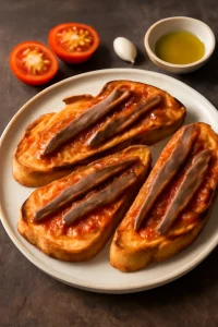 Katalán étel, pirított kenyér, érett paradicsom és anchovák